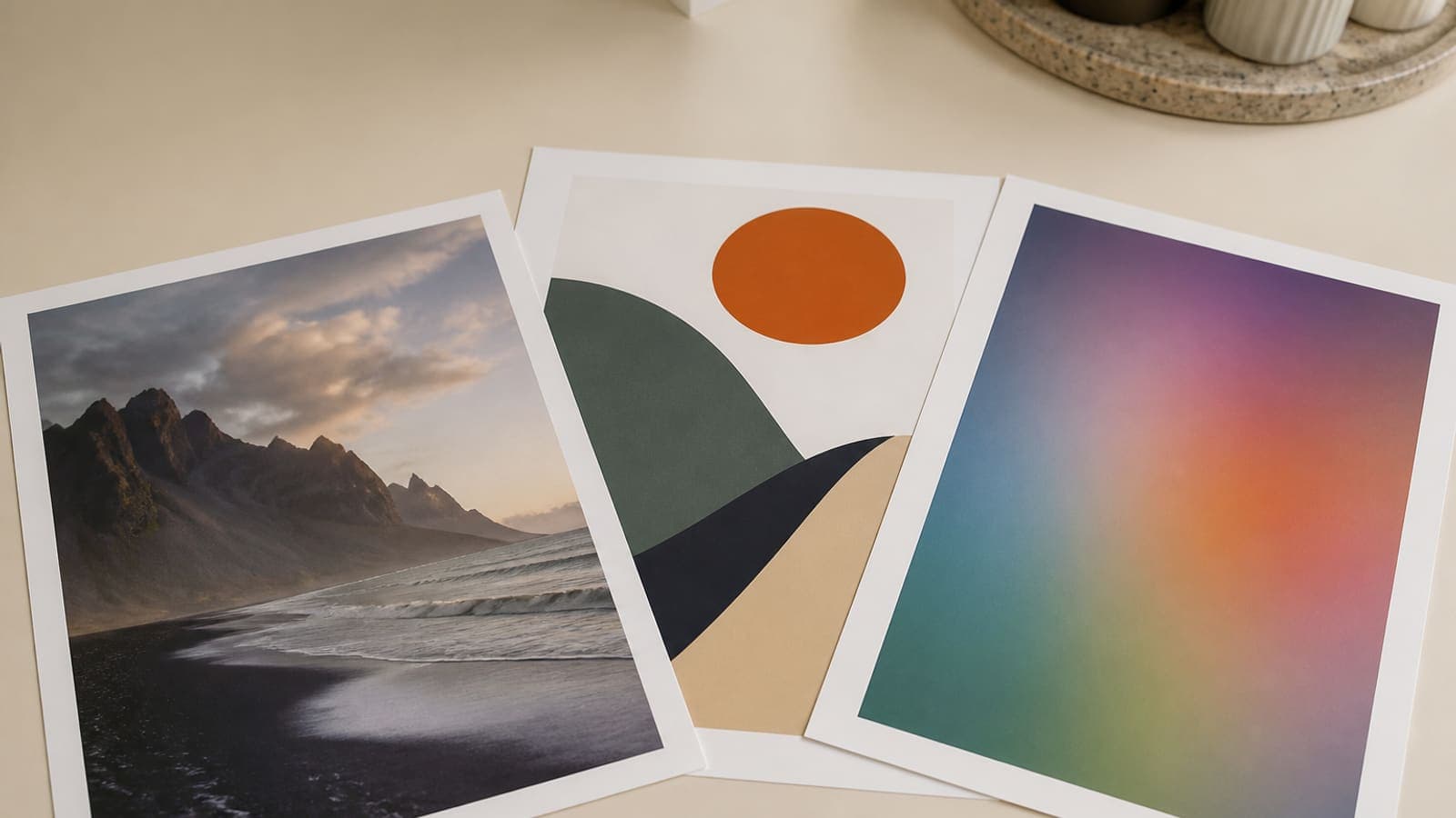 Three printed sheets on a cream desk showing a photographic print, a crisp graphic illustration, and a digital proof